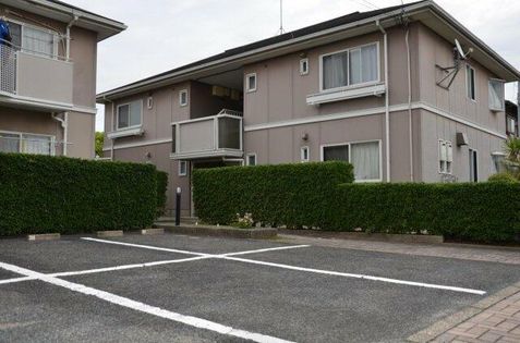 垣根があり、前は駐車場です。夜間は外灯が付く